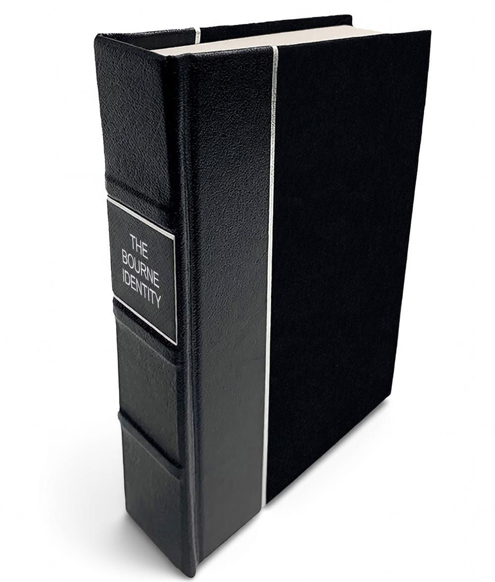 The Bourne Identity by Robert Ludlum - All-Black Leather-Bound Book - angled front-and-spine hero view